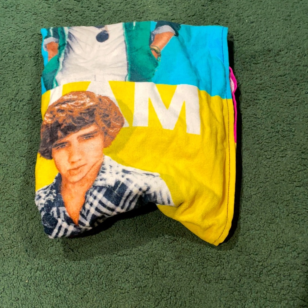 1D beach towel never used. With a Louis key chain.